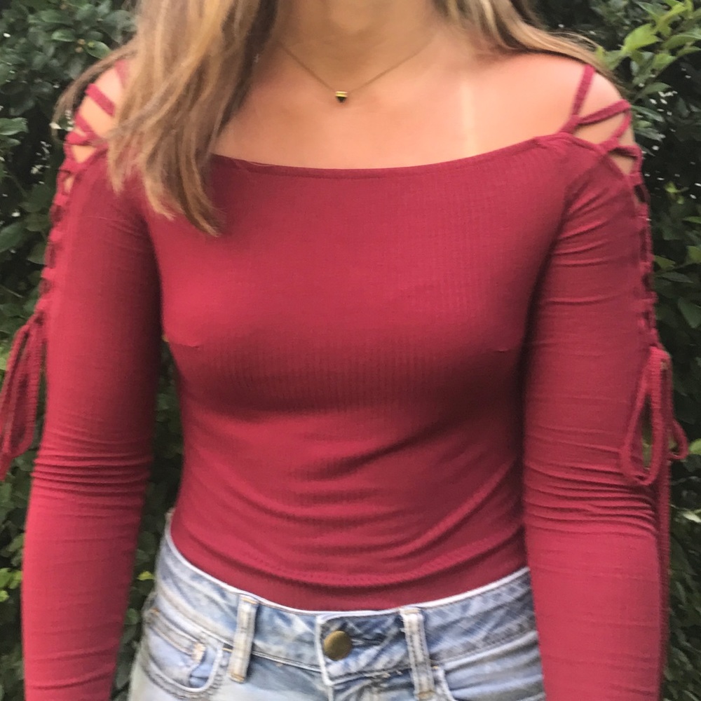 Red body suit with lace up on arms